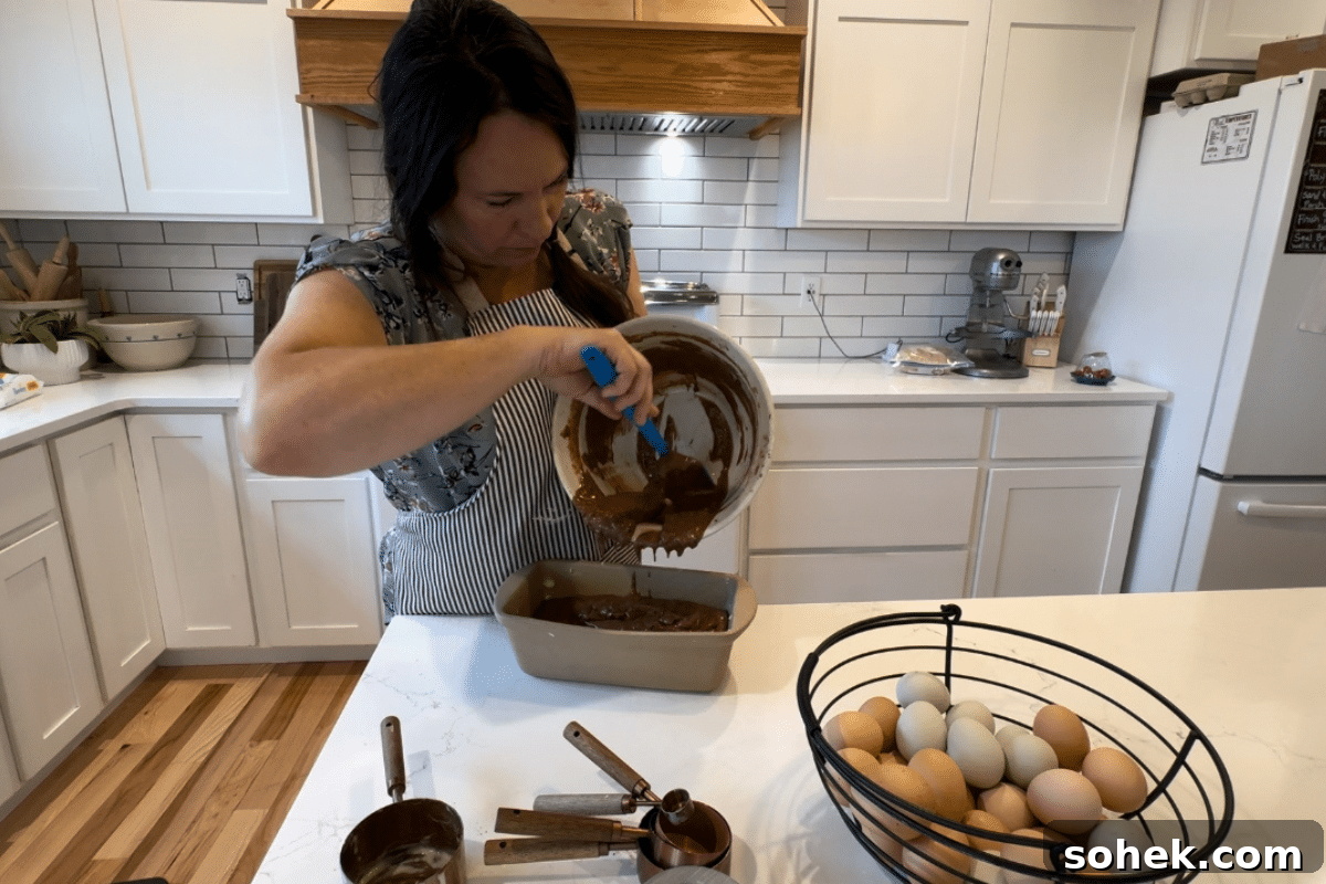 making sourdough chocolate banana bread pouring batter into pan
