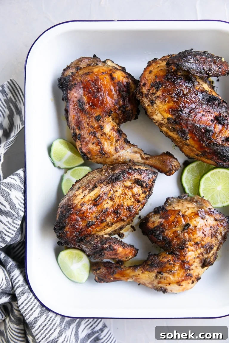 Tray filled with four pieces of grilled jerk chicken.