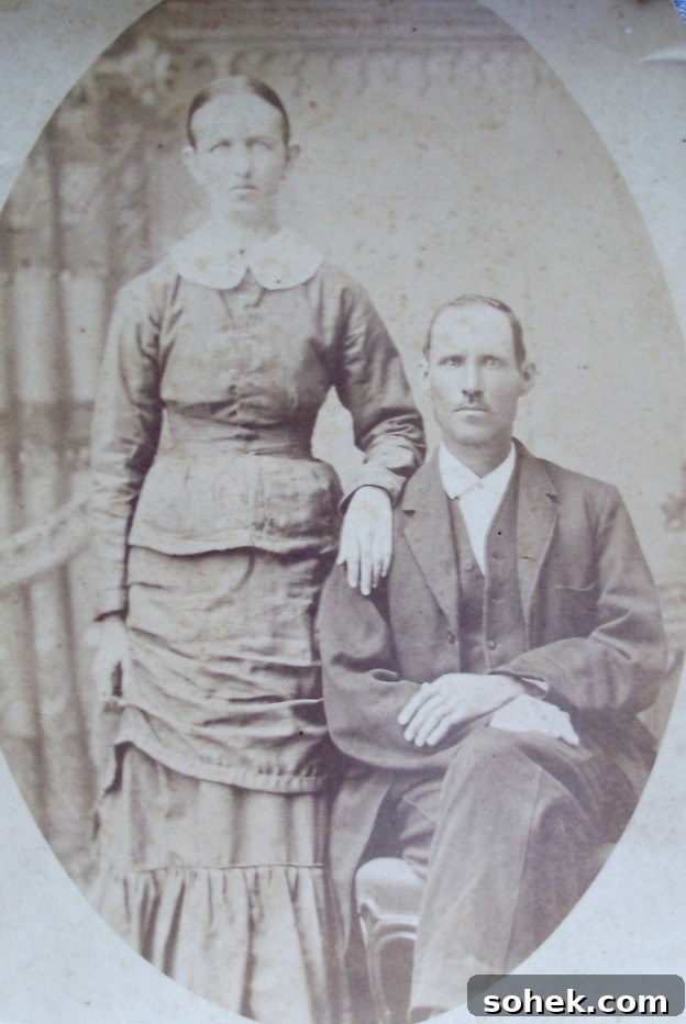 1883 black and white photo of Clara and William Haley. Clara is standing with hand on William shoulder. William is sitting.